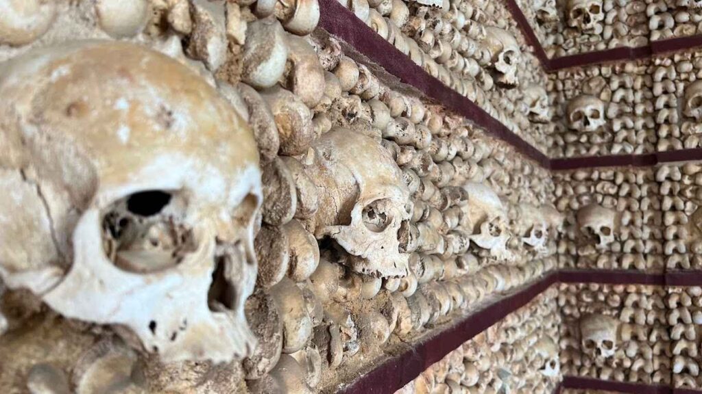 A view inside Faro’s Bone Chapel, where human bones adorn the walls in a neoclassical style.