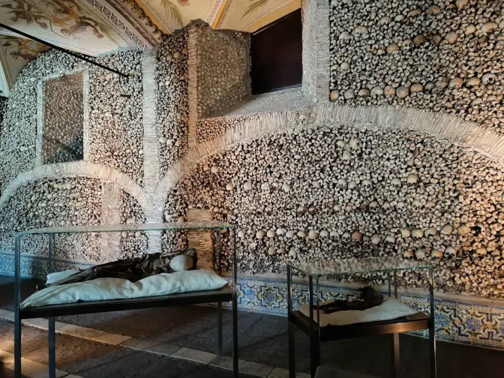 Close-up of skulls arranged in intricate patterns inside the Chapel of Bones in Évora