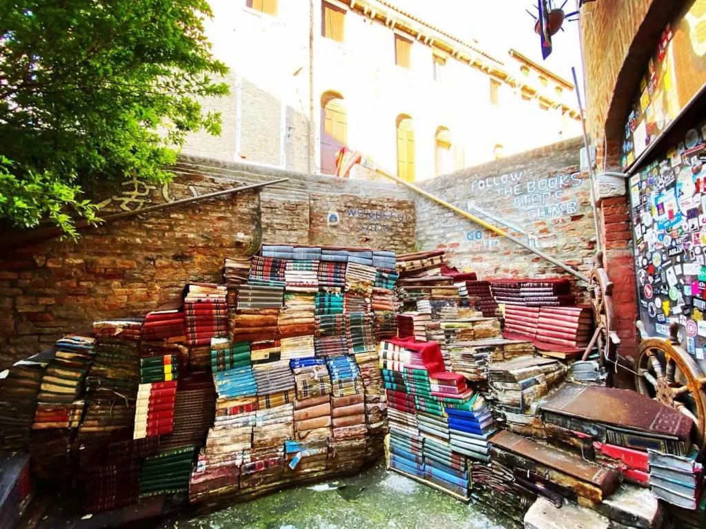 staircase made of books with a view of the Venice canal
