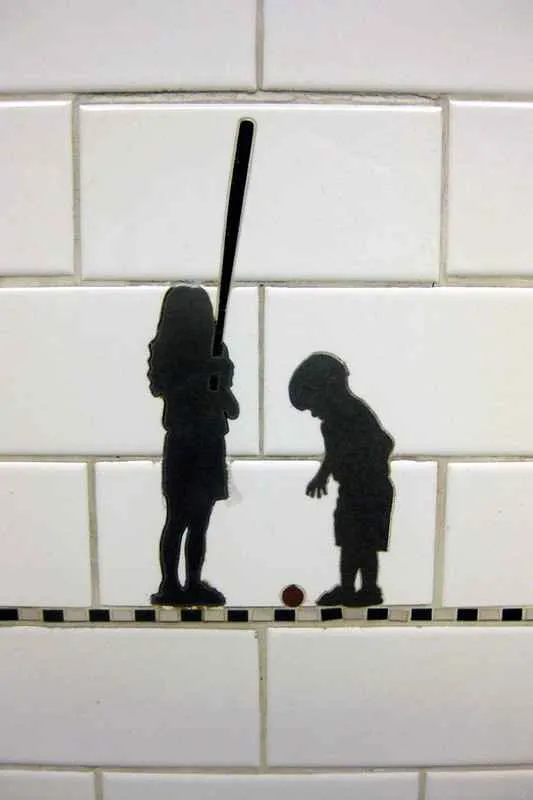 Silhouettes of people carrying objects at Prince Street station platform wall.