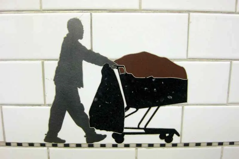 A row of silhouette figures in motion at Prince Street station.