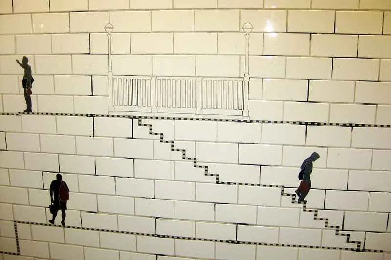 Human-shaped figures carrying items at Prince Street station
