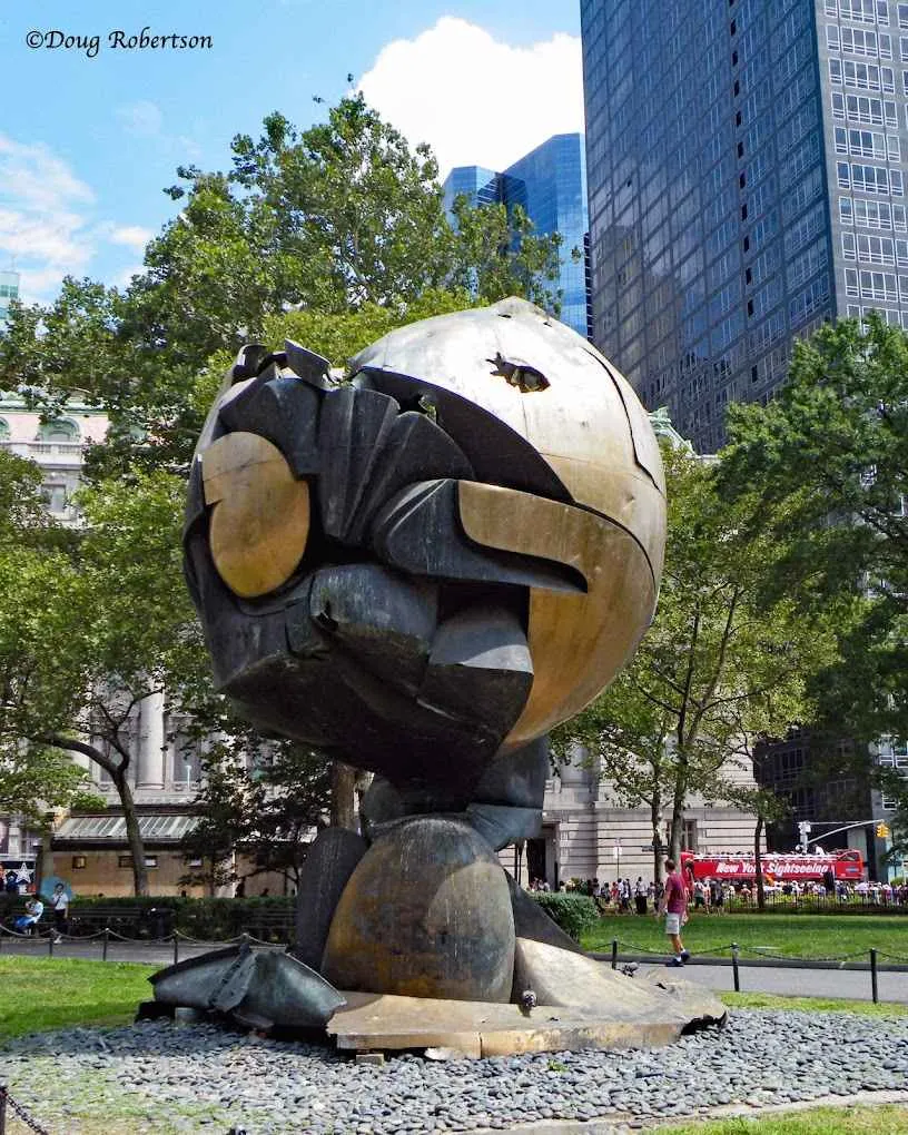 The monumental Koenig Sphere surrounded by greenery in Liberty Park