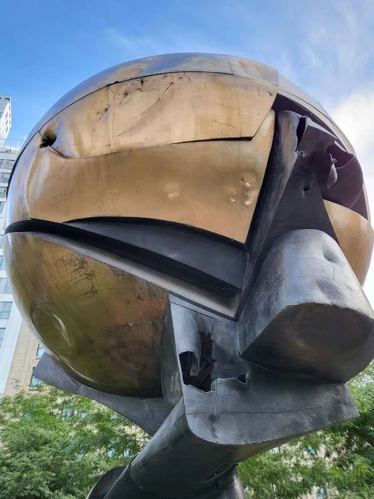 The iconic bronze Koenig Sphere with visible scars from 9/11