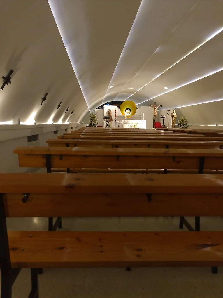 Interior of the Bridge Chapel, with simple benches and soft light filtering in from the ends.