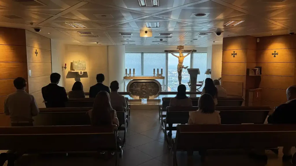 Workers attending morning mass in a chapel suspended among office floors