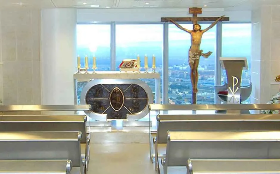 Minimalist interior of the chapel at 136 meters high, with a simple altar and natural light