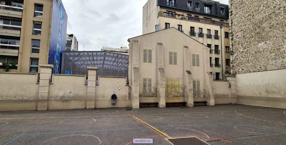The former facade of the Paris wash house is now part of a school playground.