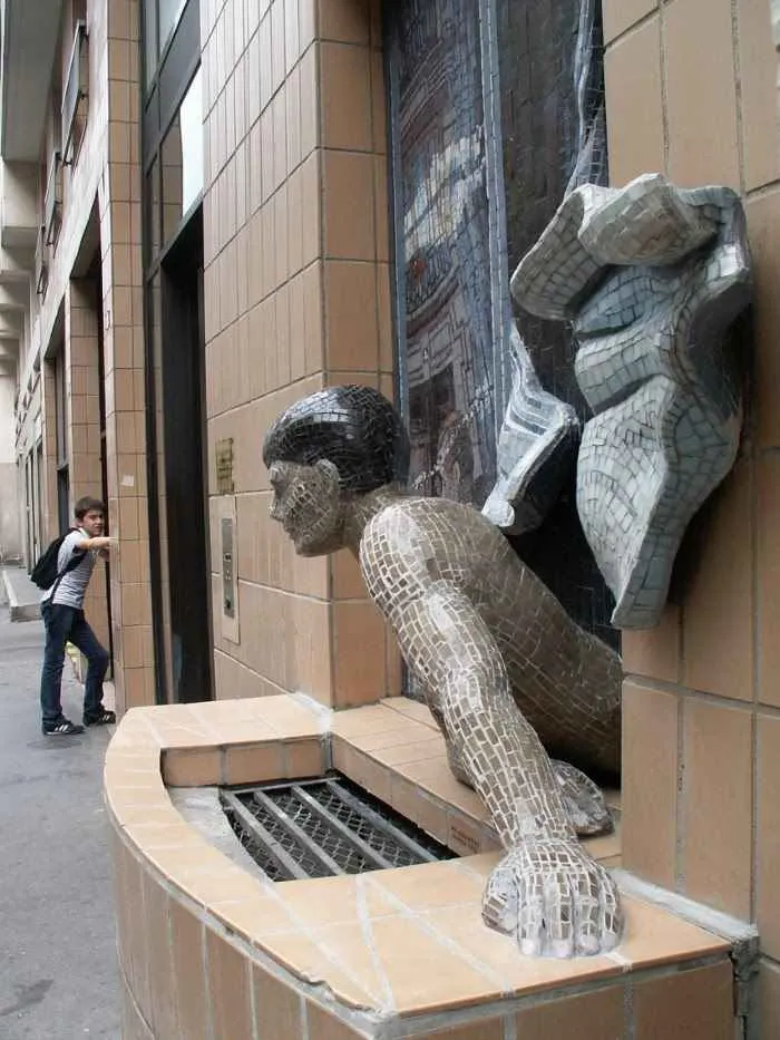 Sculpture of a man looking out the window in Montmartre
