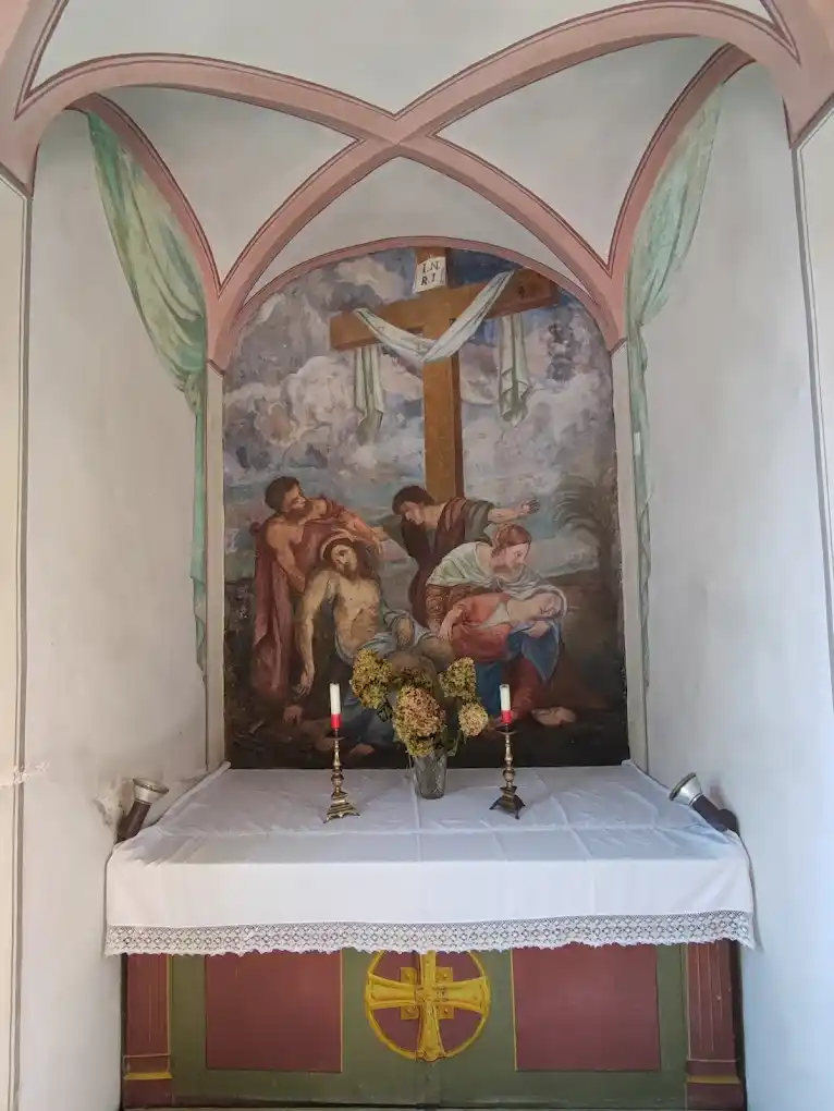 Church interior with old frescoes on the walls and natural light coming through the windows.