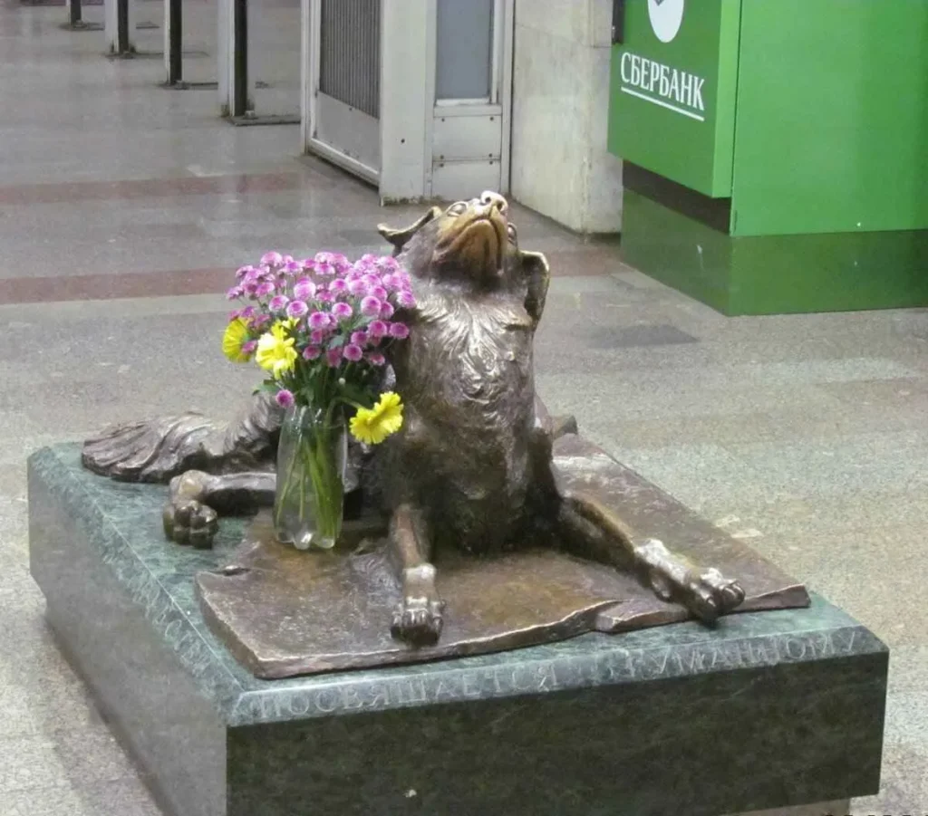 statue of a stray dog with purple flowers