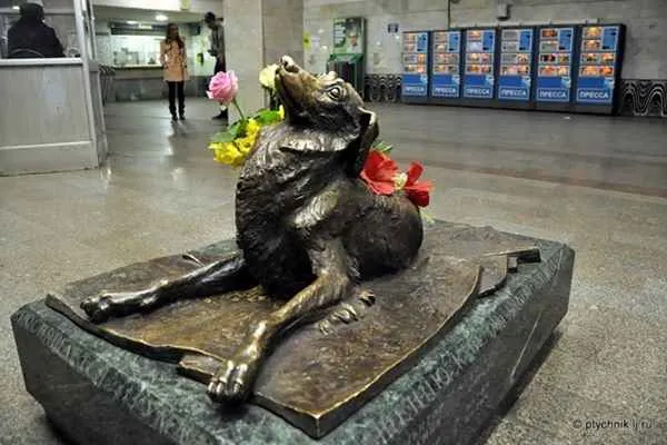 Statue of the dog Malchik with flowers in the Moscow metro